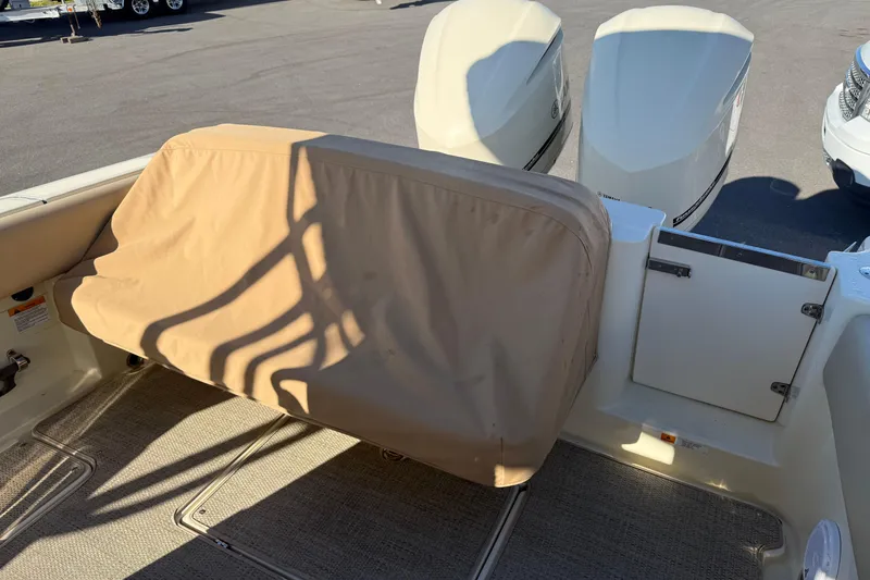 Slide: The Image of 2015 Chris-Craft 291 Catalina with cover and engines in the background. - 12