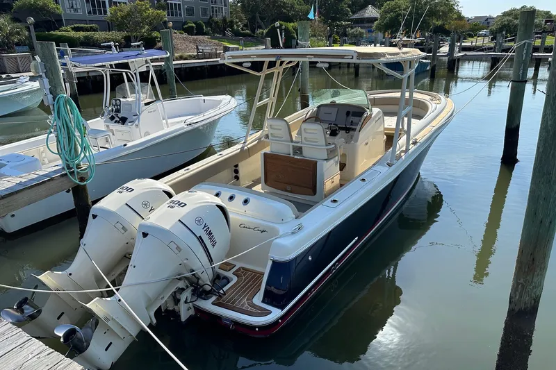 Slide: The Image of 2015 Chris-Craft 291 Catalina boat docked with twin Yamaha engines. - 19
