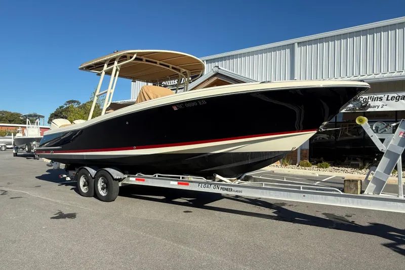 Slide: The Image of 2015 Chris-Craft 291 Catalina boat on trailer, parked outside a building. - 2
