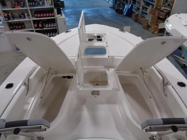 Slide: The Image of 2023 Robalo 246 Cayman boat with open storage compartments inside. - 4
