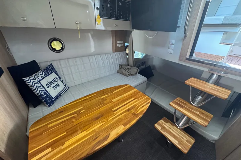 Slide: The Image of Interior of 2020 Evolve 360HT yacht with cozy seating, wooden table, and nautical decor. - 14