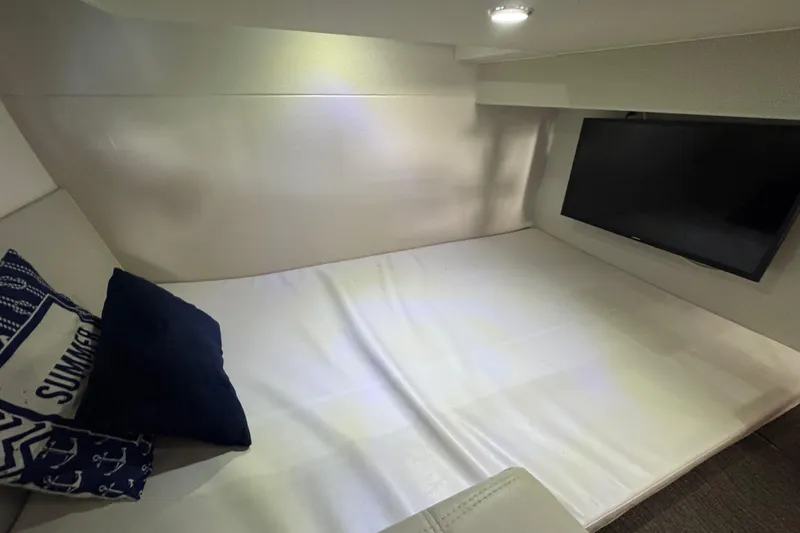 Slide: The Image of Cozy interior of 2020 Evolve 360HT with bed, pillows, and wall-mounted TV. - 16