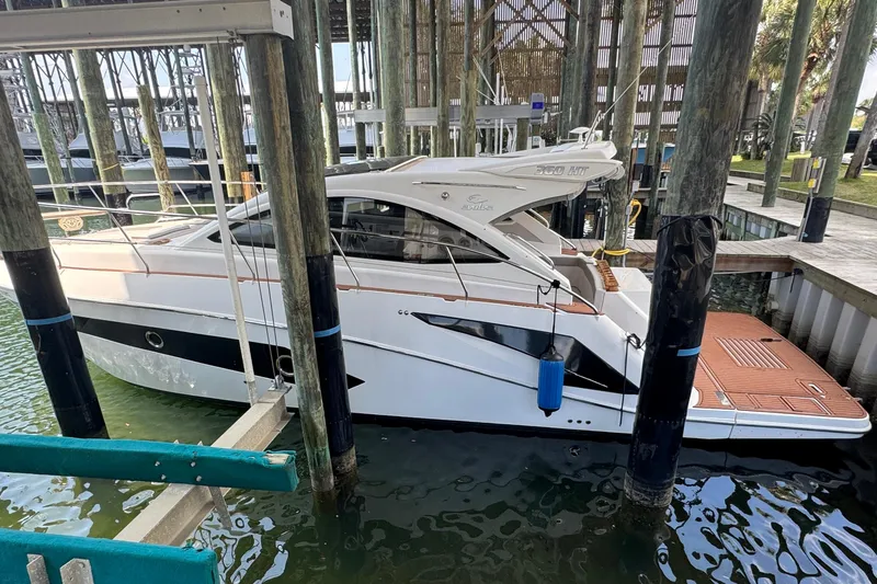 Slide: The Image of 2020 Evolve 360HT yacht docked in a marina, side view. - 2