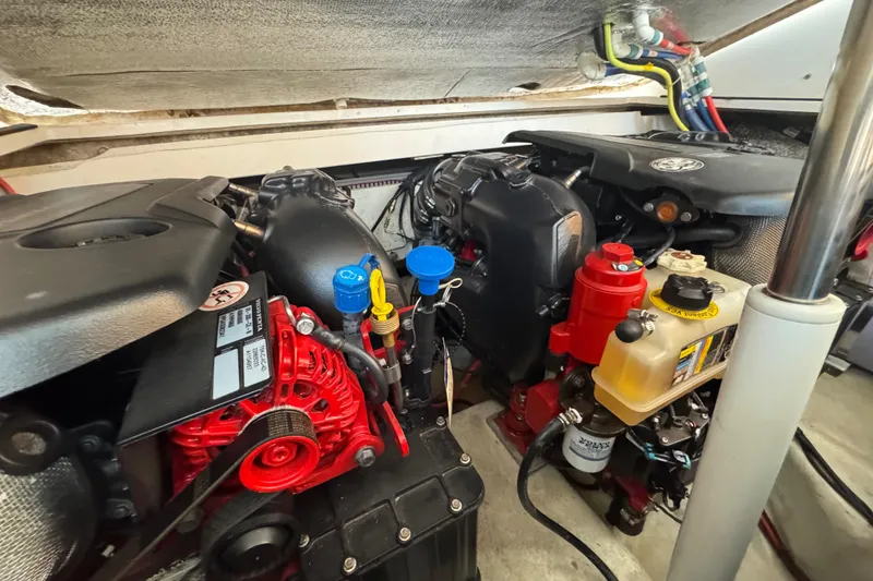 Slide: The Image of Engine compartment of a 2020 Evolve 360HT boat, showcasing various components and wiring. - 21
