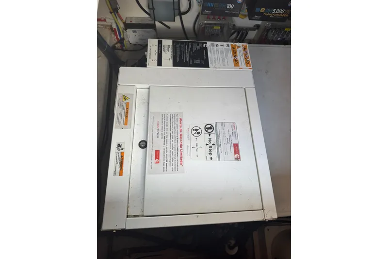 Slide: The Image of Evolve 360HT 2020 model with warning labels and control panel in a utility room. - 23