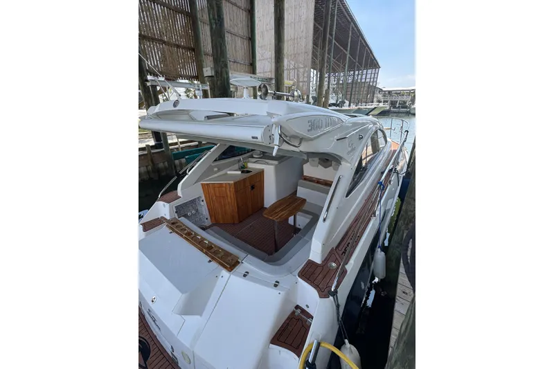 Slide: The Image of 2020 Evolve 360HT yacht docked, showcasing sleek design and spacious deck area. - 3