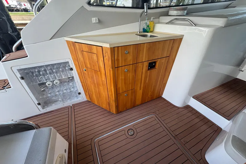 Slide: The Image of 2020 Evolve 360HT yacht interior with wooden cabinetry and sink. - 6