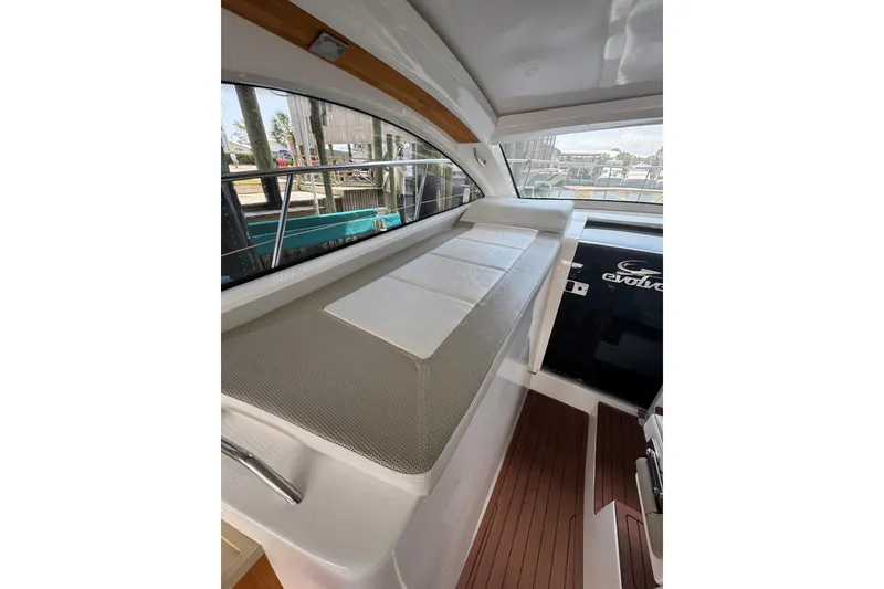 Slide: The Image of Interior view of 2020 Evolve 360HT yacht with cushioned seating and wooden flooring. - 7
