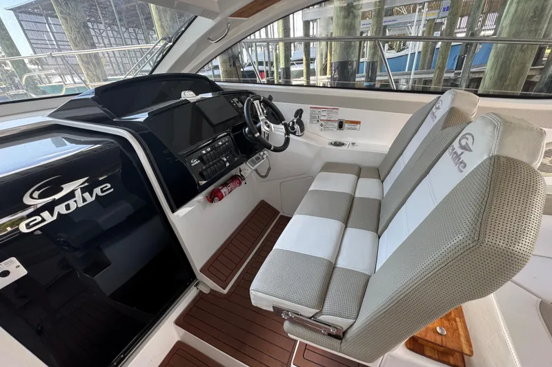 Slide: The Image of Interior of 2020 Evolve 360HT boat with dual seats and modern dashboard. - 8