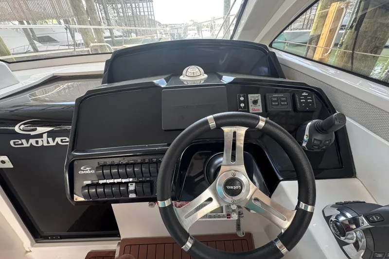 Slide: The Image of Cockpit of 2020 Evolve 360HT boat with steering wheel and control panel. - 9