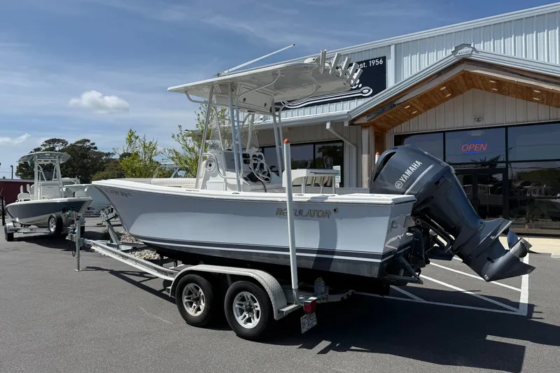 Slide: The Image of 2004 Regulator 21 Forward Seating boat on trailer outside dealership. - 11