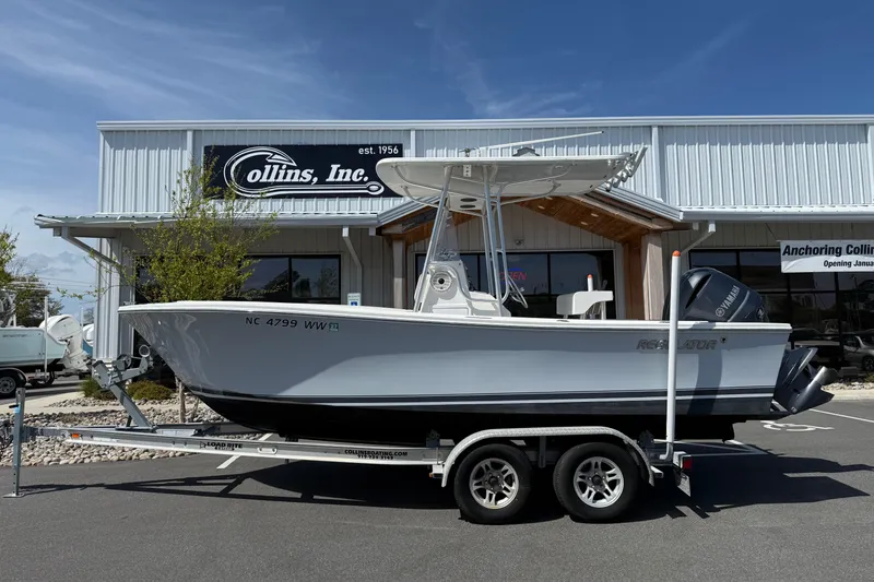 Slide: The Image of 2004 Regulator 21 Forward Seating boat on trailer outside Collins, Inc. dealership. - 12