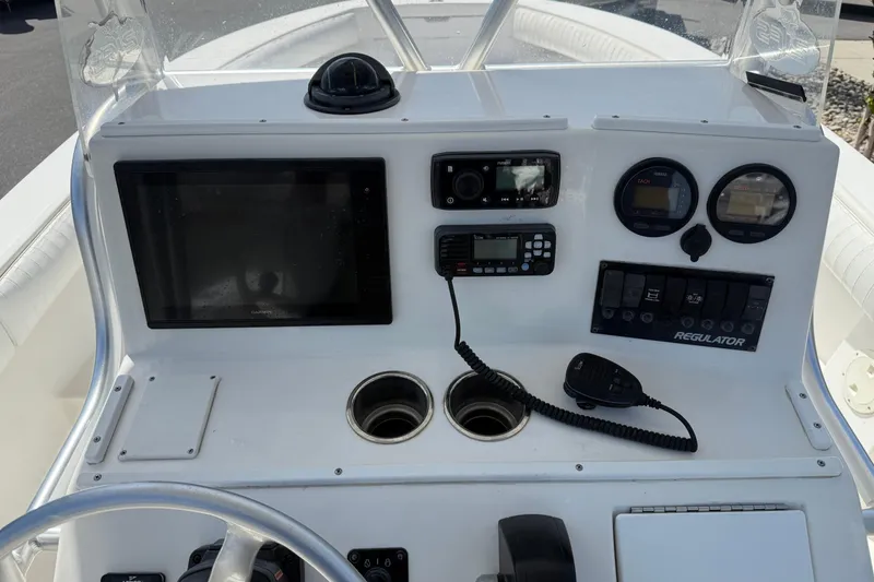 Slide: The Image of 2004 Regulator 21 Forward Seating boat dashboard with navigation and communication equipment. - 6