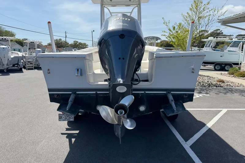 Slide: The Image of 2004 Regulator 21 Forward Seating boat with outboard motor, parked in a marina. - 7