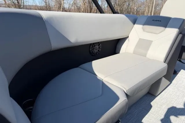 Slide: The Image of 2026 Alera A22Q boat interior with gray seating and speaker detail. - 15
