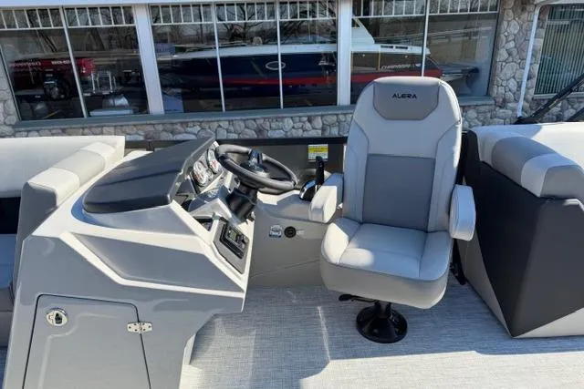 Slide: The Image of Captain's seat and helm of 2026 Alera A22Q boat, featuring modern controls and sleek design. - 18