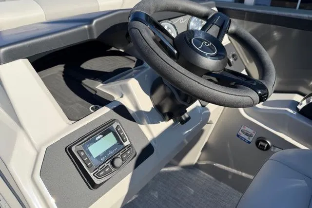 Slide: The Image of Steering wheel and dashboard of 2026 Alera A22Q boat, featuring modern controls. - 19