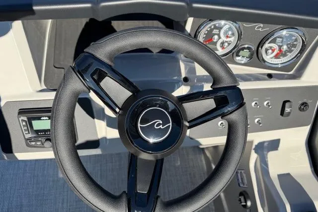 Slide: The Image of Steering wheel and dashboard of 2026 Alera A22Q boat with gauges and controls. - 21