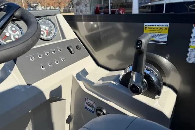 Slide: The Image of Control panel of 2026 Alera A22Q boat with steering wheel and throttle lever. - 23