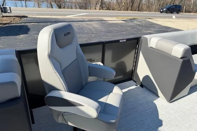 Slide: The Image of Alera A22Q 2026 boat seat, gray upholstery, parked near a road with trees in background. - 31