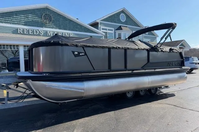 Slide: The Image of 2026 Alera A22Q pontoon boat parked at Reeds Marine dealership. - 35