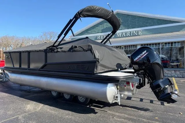 Slide: The Image of 2026 Alera A22Q pontoon boat with Mercury engine, parked outside a marine store. - 36