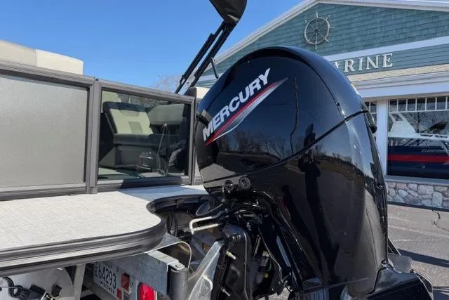 Slide: The Image of Alera A22Q 2026 boat with Mercury outboard motor, parked near a marine building. - 5