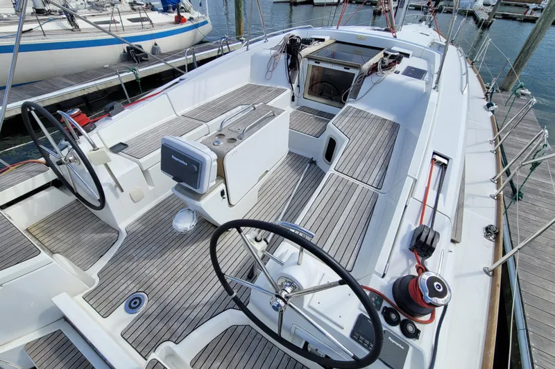 Slide: The Image of 2017 Jeanneau Sun Odyssey 44 DS sailboat cockpit with dual steering wheels and teak decking. - 10