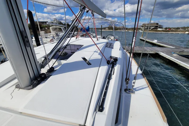 Slide: The Image of 2017 Jeanneau Sun Odyssey 44 DS sailboat docked at marina under blue sky. - 17