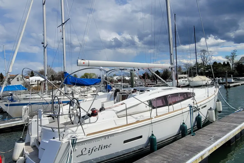 Slide: The Image of 2017 Jeanneau Sun Odyssey 44 DS sailboat docked at marina under cloudy sky. - 2
