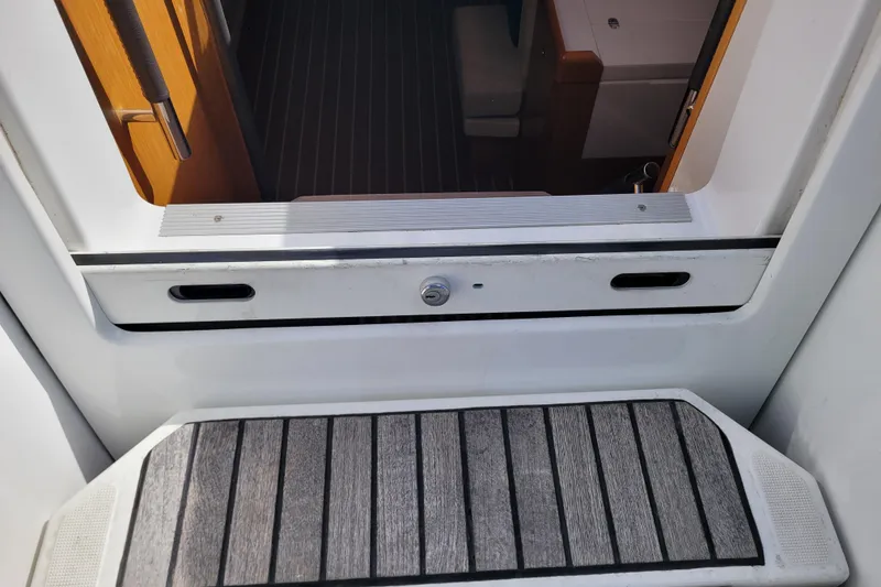 Slide: The Image of Entrance to Jeanneau Sun Odyssey 44 DS yacht, showcasing teak steps and interior view. - 21