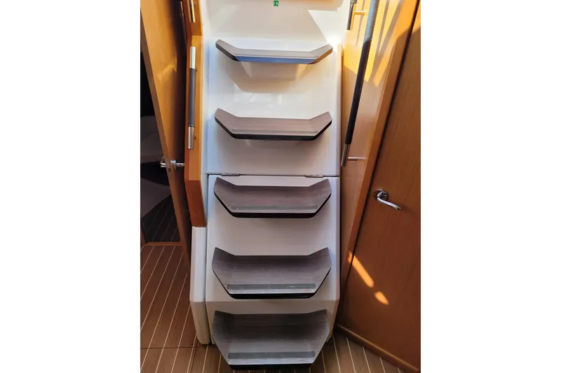 Slide: The Image of Staircase inside 2017 Jeanneau Sun Odyssey 44 DS yacht, featuring sleek wooden steps. - 23