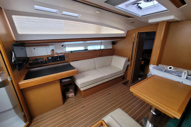 Slide: The Image of Interior of 2017 Jeanneau Sun Odyssey 44 DS yacht with modern furnishings and navigation equipment. - 24