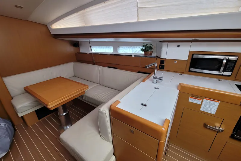 Slide: The Image of Interior of 2017 Jeanneau Sun Odyssey 44 DS yacht with modern kitchen and seating area. - 25