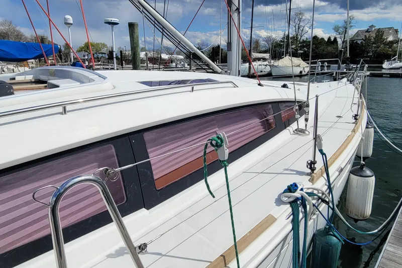 Slide: The Image of 2017 Jeanneau Sun Odyssey 44 DS sailboat docked, showcasing sleek design and modern features. - 3