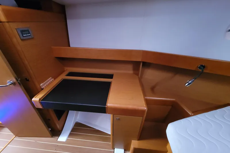 Slide: The Image of Interior of 2017 Jeanneau Sun Odyssey 44 DS yacht with wooden desk and seating area. - 30