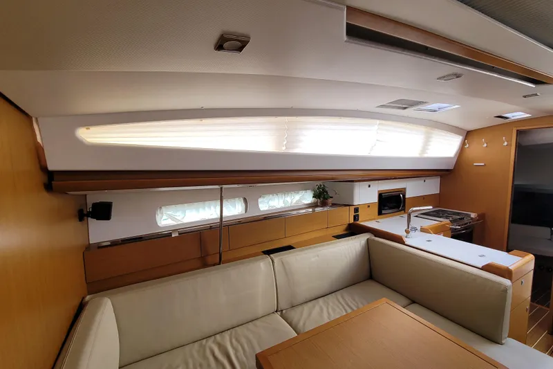 Slide: The Image of Interior of 2017 Jeanneau Sun Odyssey 44 DS yacht, featuring modern kitchen and seating area. - 31