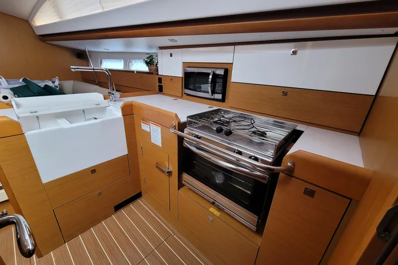 Slide: The Image of Modern kitchen interior of 2017 Jeanneau Sun Odyssey 44 DS yacht, featuring stove and microwave. - 35