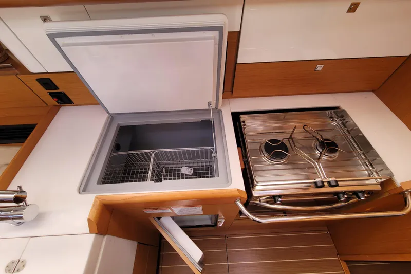 Slide: The Image of Galley kitchen in 2017 Jeanneau Sun Odyssey 44 DS yacht with stove and fridge. - 37
