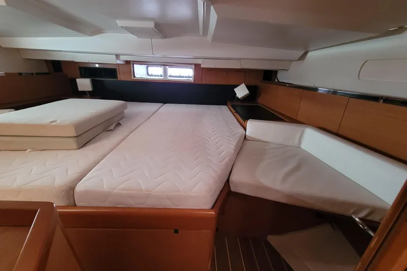 Slide: The Image of Interior cabin of 2017 Jeanneau Sun Odyssey 44 DS yacht with bed and seating area. - 42
