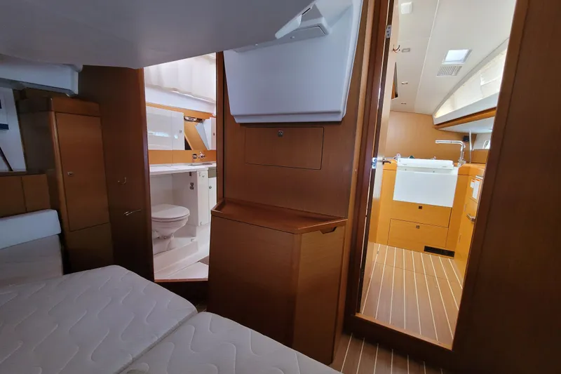 Slide: The Image of Interior of 2017 Jeanneau Sun Odyssey 44 DS yacht, featuring a cozy cabin and bathroom. - 44
