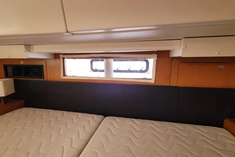 Slide: The Image of Interior cabin of 2017 Jeanneau Sun Odyssey 44 DS yacht with window and bed. - 58
