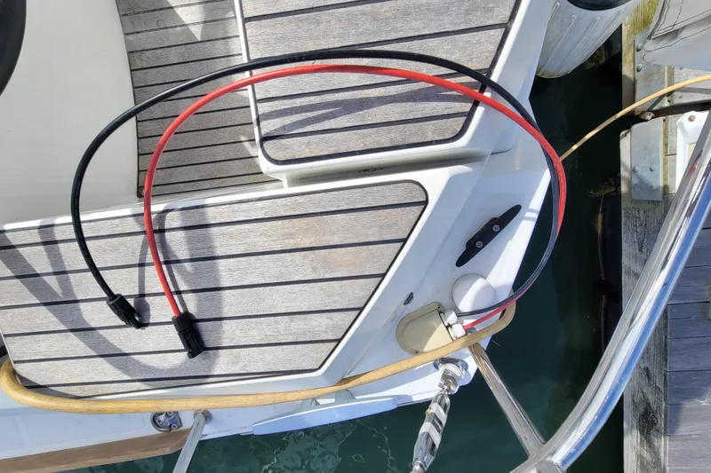 Slide: The Image of Deck of 2017 Jeanneau Sun Odyssey 44 DS with cables and dock view. - 59