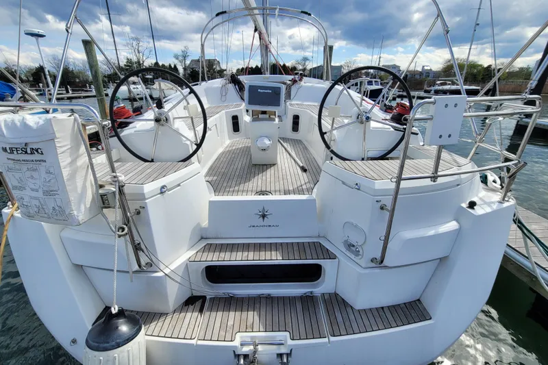 Slide: The Image of 2017 Jeanneau Sun Odyssey 44 DS sailboat with dual steering wheels at a marina. - 6