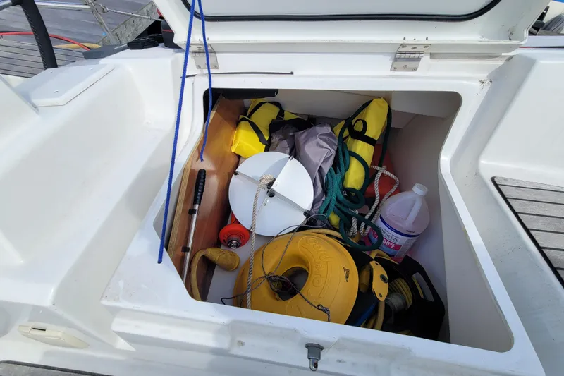 Slide: The Image of Open storage compartment on 2017 Jeanneau Sun Odyssey 44 DS sailboat with boating equipment. - 65