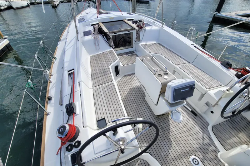 Slide: The Image of 2017 Jeanneau Sun Odyssey 44 DS sailboat cockpit with dual steering wheels and teak decking. - 7