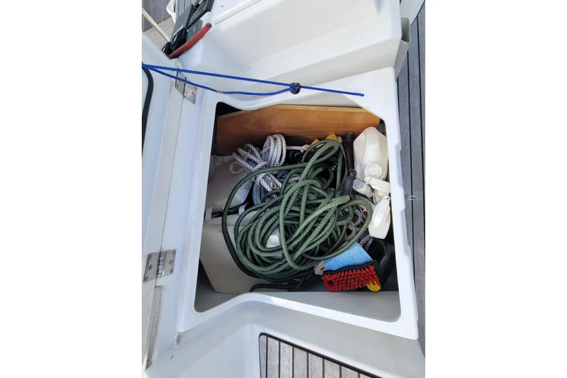 Slide: The Image of Storage compartment on 2017 Jeanneau Sun Odyssey 44 DS with ropes and cleaning supplies. - 70