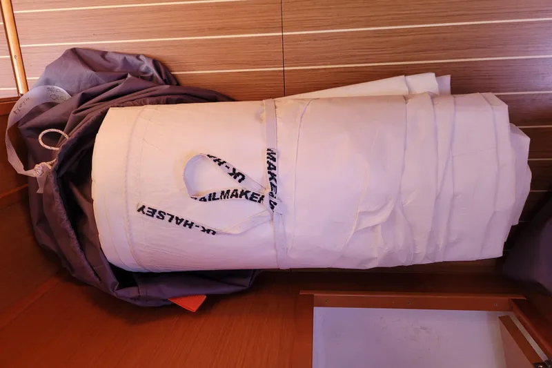 Slide: The Image of Rolled sail inside Jeanneau Sun Odyssey 44 DS, 2017 model, wooden interior background. - 74