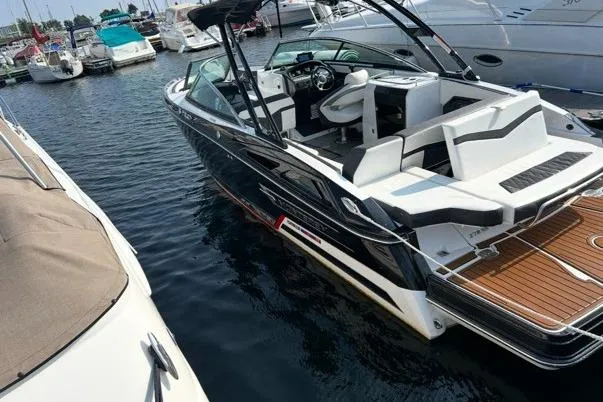 Slide: The Image of 2020 Monterey 278SS Super Sport boat docked in marina, featuring sleek design and spacious seating. - 1