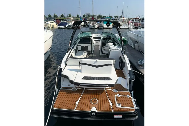 Slide: The Image of 2020 Monterey 278SS Super Sport boat docked at marina, featuring sleek design and spacious seating. - 10